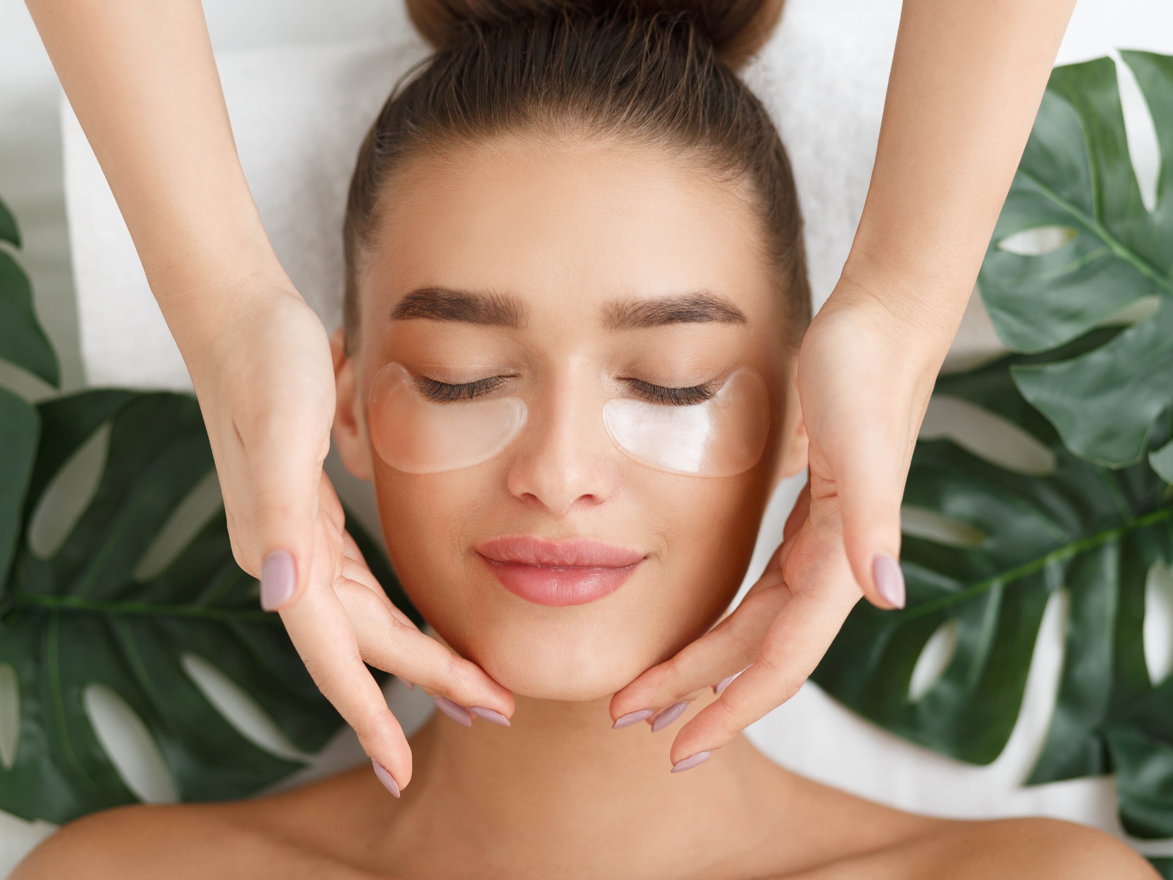 Woman receiving a holistic facial treatment, representing KarenMariaGlobal's holistic beauty and wellness studio in Tenerife